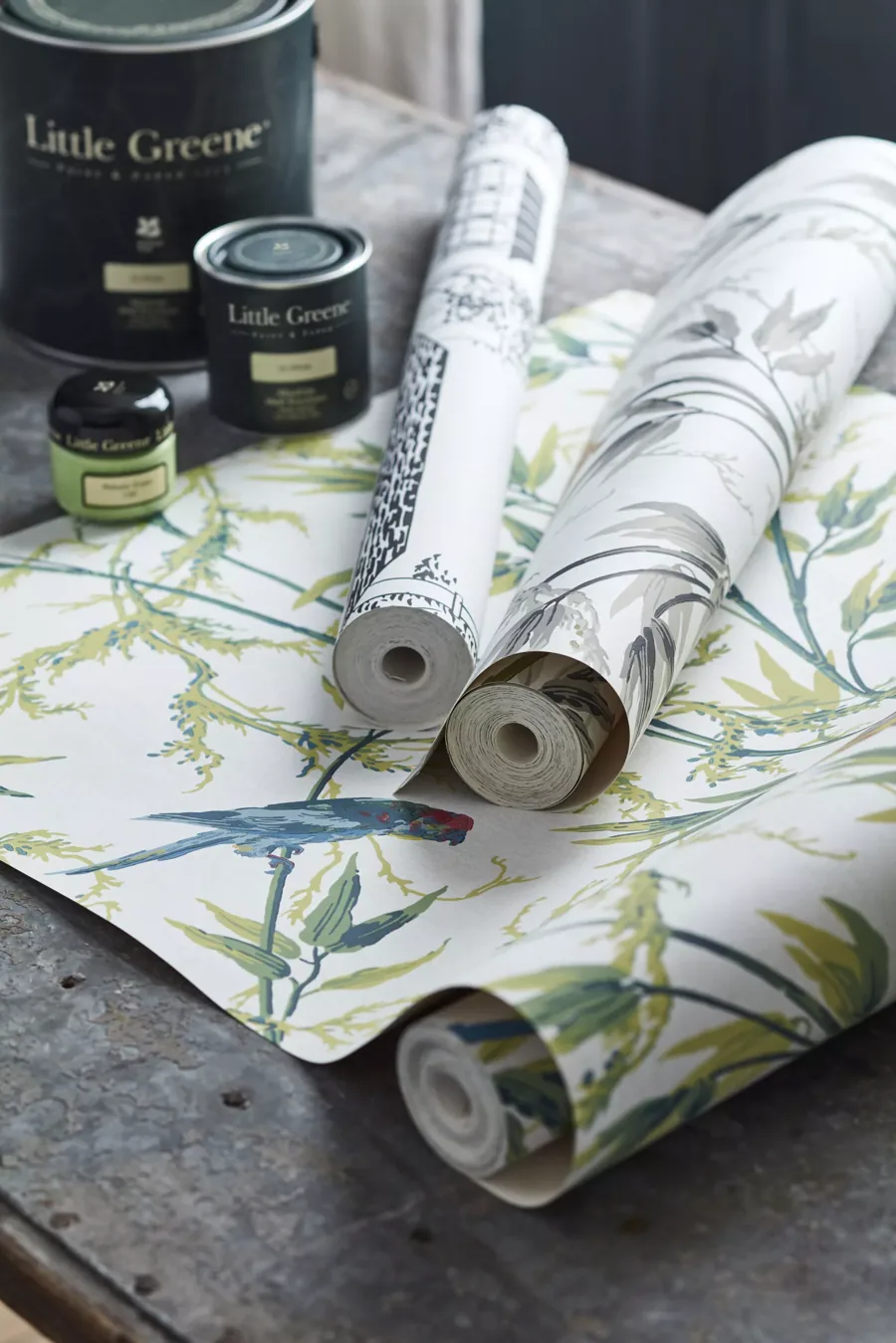 Little Greene paint tins and rolled wallpaper featuring a bird motif