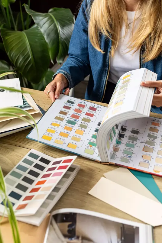 A customer browsing paint swatch books